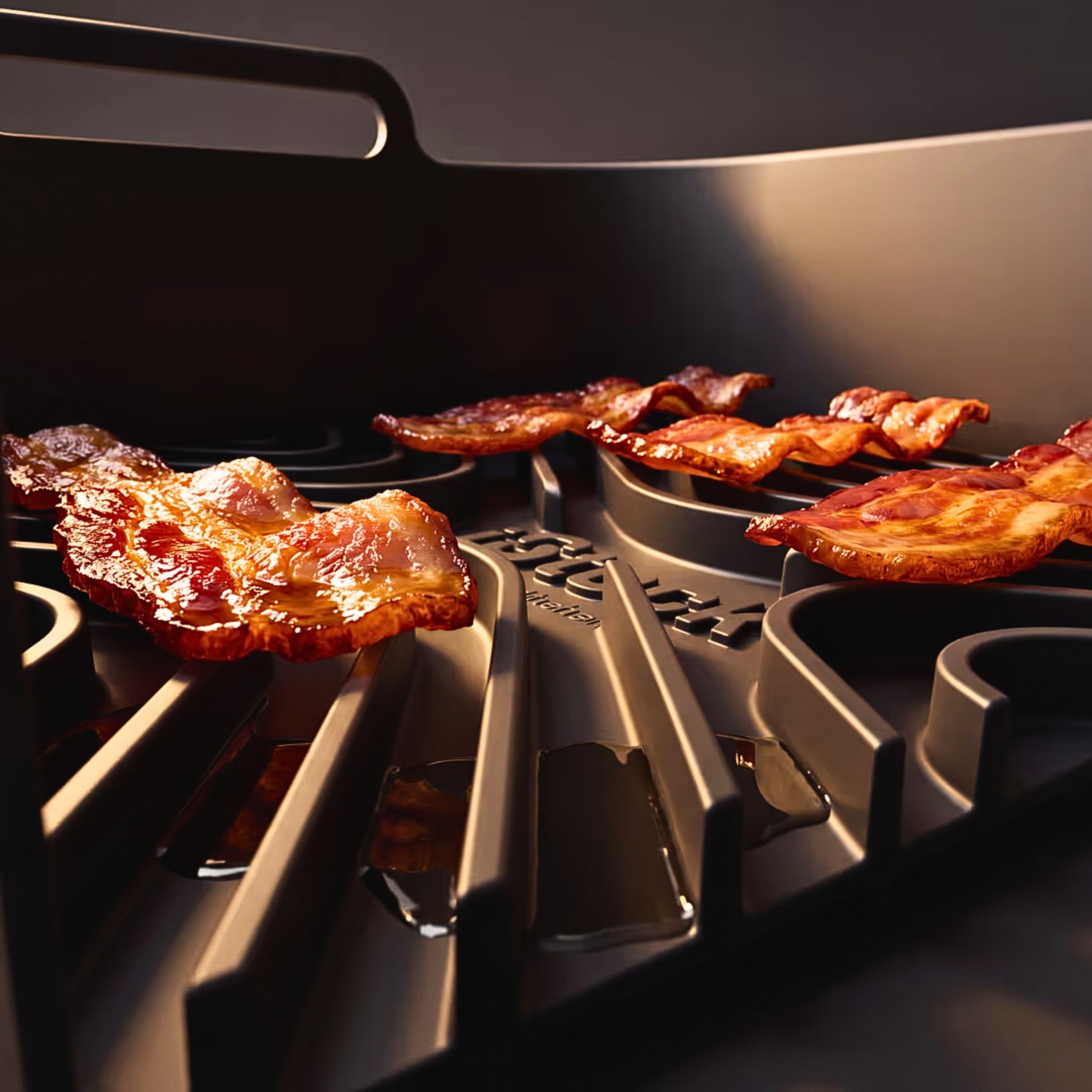 Crisp bacon cooking on an iStock Kitchen liner